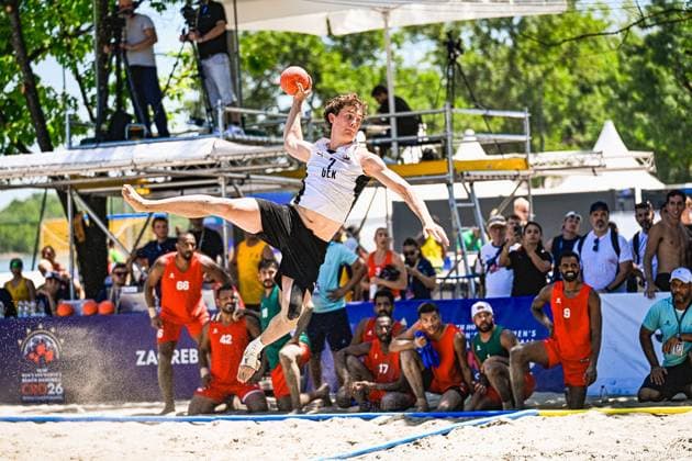 Ein Spieler der deutschen Beachhandball-Nationalmannschaft springt mit ausgestrecktem Wurfarm und Ball in der Hand weit über den Sand am Jarun See in Zagreb. Im Hintergrund verfolgen Zuschauer und Gegenspieler in roten Trikots die Aktion. IHF Beach Handball World Championship, WM, Weltmeisterschaft 2026, 23.06.2026, Zagreb, Jarun See *** A player on the German national beach handball team leaps far across the sand at Lake Jarun in Zagreb, with his throwing arm outstretched and the ball in his hand. In the background, spectators and opposing players in red jerseys watch the action at the 2026 IHF Beach Handball World Championship, June 23, 2026, Zagreb, Lake Jarun Copyright: xspeedshotx xDorianfrickx