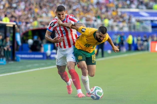 SANTA CLARA, CA - JUNE 25: Juan Jose Caceres 4 of Paraguay and Aziz Behich 16 of Australia fight for the ball during the FIFA World Cup, WM, Weltmeisterschaft, Fussball Group D match between Paraguay and Australia on June 25, 2026 at San Francisco Bay Area Stadium in Santa Clara, CA. (Photo by Bob Kupbens Icon Sportswire) SOCCER: JUN 25 FIFA World Cup 26 Group D - Paraguay vs Australia EDITORIAL USE ONLY Icon260625021