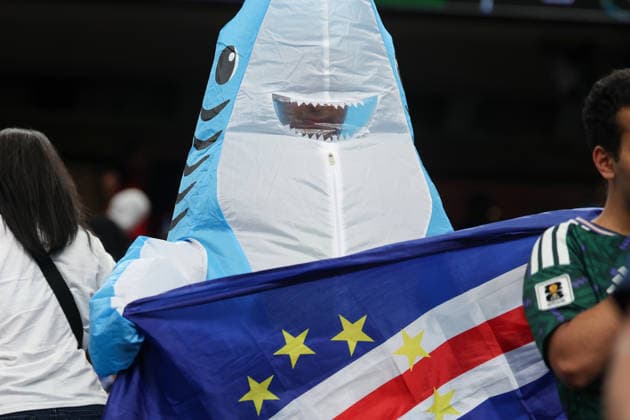 HOUSTON, TX - JUNE 26: A Cabo Verde fan wears a blow up shark costume and holds the Cabo Verde flag ahead of the FIFA World Cup, WM, Weltmeisterschaft, Fussball 2026 Group H match between Cabo Verde and Saudi Arabia on June 26, 2026, at Houston Stadium in Houston, Texas. (Photo by David Buono Icon Sportswire). SOCCER: JUN 26 FIFA World Cup 26 Group H - Cabo Verde vs Saudi Arabia EDITORIAL USE ONLY Icon260626012