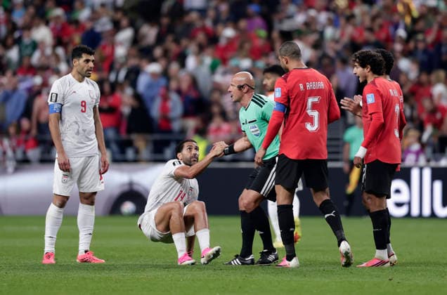 (260627) -- SEATTLE, June 27, 2026 -- Referee Szymon Marciniak (3rd L) helps Saman Ghoddos (2nd L) of Iran stand up during the group G match between Egypt and Iran at the 2026 FIFA World Cup, WM, Weltmeisterschaft, Fussball at Seattle Stadium in Seattle, the United States, June 26, 2026. (Photo by Xinhua) (SP)U.S.-SEATTLE-FOOTBALL-FIFA WORLD CUP-GROUP G-EGY VS IRN ArthurxDong 