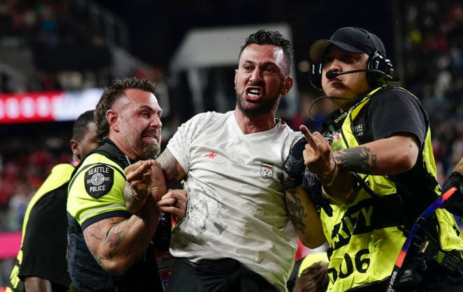 (260627) -- SEATTLE, June 27, 2026 -- A pitch invader (C) is seen removed from the field by security personnel during the group G match between Egypt and Iran at the 2026 FIFA World Cup, WM, Weltmeisterschaft, Fussball at Seattle Stadium in Seattle, the United States, June 26, 2026. (Photo by Xinhua) (SP)U.S.-SEATTLE-FOOTBALL-FIFA WORLD CUP-GROUP G-EGY VS IRN ArthurxDong 