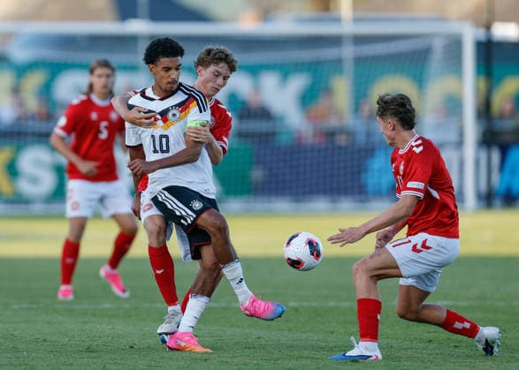 Denbighshire, Wales, 28th June 2026. Francis Onyeka of Germany passes the ball while under pressure during the Germany U19 vs Denmark U19 UEFA European U19 Championship match at Central Park, Denbighshire. Picture credit should read: Cody Froggatt Sportimage EDITORIAL USE ONLY. No use with unauthorised audio, video, data, fixture lists, club league logos or live services. Online in-match use limited to 120 images, no video emulation. No use in betting, games or single club league player publications. SPI_26_CF_GERMANY_U19_V_DENMARK_U19 SPI-4848-0023