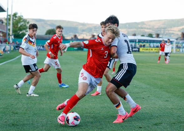 Denbighshire, Wales, 28th June 2026. Philip Sondergaard of Denmark holds off a challenge from Mirza Catovic of Germany during the Germany U19 vs Denmark U19 UEFA European U19 Championship match at Central Park, Denbighshire. Picture credit should read: Cody Froggatt Sportimage EDITORIAL USE ONLY. No use with unauthorised audio, video, data, fixture lists, club league logos or live services. Online in-match use limited to 120 images, no video emulation. No use in betting, games or single club league player publications. SPI_27_CF_GERMANY_U19_V_DENMARK_U19 SPI-4848-0024