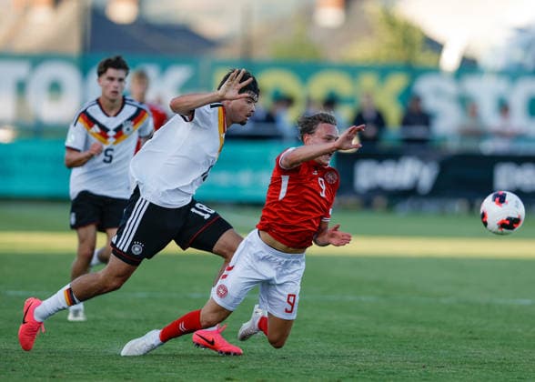 Denbighshire, Wales, 28th June 2026. Mirza Catovic of Germany fouls Alfred Gothler of Denmark during the Germany U19 vs Denmark U19 UEFA European U19 Championship match at Central Park, Denbighshire. Picture credit should read: Cody Froggatt Sportimage EDITORIAL USE ONLY. No use with unauthorised audio, video, data, fixture lists, club league logos or live services. Online in-match use limited to 120 images, no video emulation. No use in betting, games or single club league player publications. SPI_21_CF_GERMANY_U19_V_DENMARK_U19 SPI-4848-0025