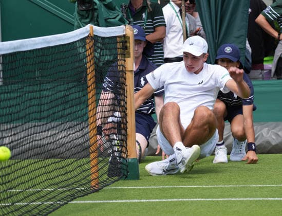 Tennis - 2026 Wimbledon Championships - Day One (Week One) - All England Lawn Tennis & Croquet Club, London - Monday 29th June 2026 Men™s Singles, First Round: Arthur Rinderknech (FRA) vs. Oliver Tarvet (GBR) Oliver Tarvet falls into the ball boys at the net COLORSPORT ANDREW COWIE 