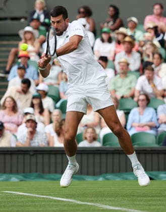 Serbian Novak Djokovic plays a backhand in his match against China s Yibing Wu on day one of the 2026 Wimbledon Championships in London on Monday, June 29, 2026.  LON2026062965 HUGOxPHILPOTT