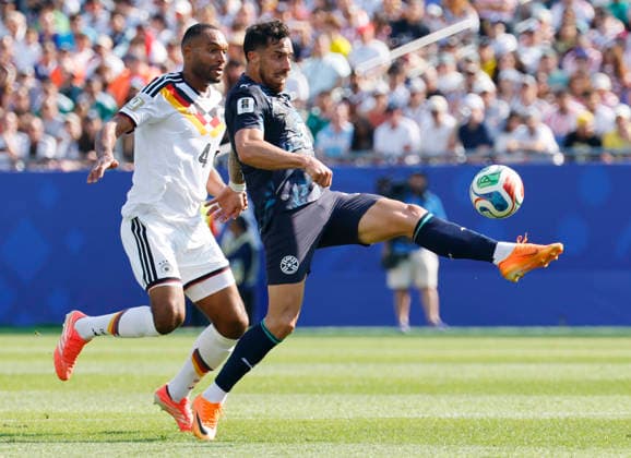 Paraguay s Gabriel Avalos (21) keeps the ball from Germany s Jonathan Tah in the first half of a FIFA World Cup, WM, Weltmeisterschaft, Fussball match at Boston Stadium in Boston on Monday, June 29, 2026.  BOS20260629810 CJxGUNTHER