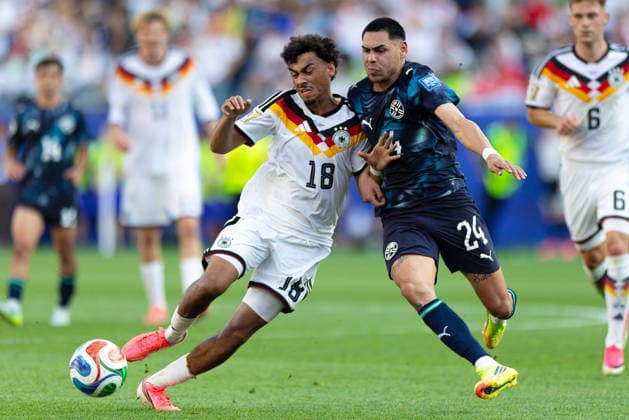 June 29, 2026; Foxborough, Massachusetts, USA; Germany defender Nathaniel Brown (18) shields the ball from Paraguay midfielder Gustavo Caballero (24) in a FIFA World Cup, WM, Weltmeisterschaft, Fussball 2026 Round of 32 match between Germany and Paraguay at Boston Stadium. (c) CSM - ZUMAc04_ 20260629_zma_c04_094 Copyright: xBurtxGranofskyx