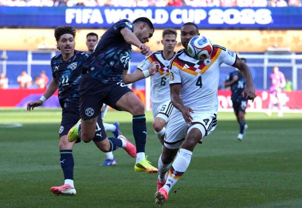 (260630) -- BOSTON, June 30, 2026 -- Gustavo Caballero (front L) of Paraguay vies with Jonathan Tah (front R) of Germany during the round of 32 match between Germany and Paraguay at the 2026 FIFA World Cup, WM, Weltmeisterschaft, Fussball at Boston Stadium in Boston, the United States, June 29, 2026. ) (SP)U.S.-BOSTON-FOOTBALL-FIFA WORLD CUP-ROUND OF 32-GER VS PRY ChenxYichen 