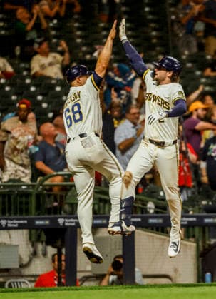 Milwaukee Brewers second baseman Brice Turang (R) celebrates with Milwaukee Brewers third base coach Matt Erickson (L) after hitting a home run in the seventh inning of the MLB, Baseball Herren, USA game between the Cincinnati Reds and the Milwaukee Brewers at American Family Field in Milwaukee, Wisconsin on Monday, June 29, 2026.  MIL20260629840 TANNENxMAURY