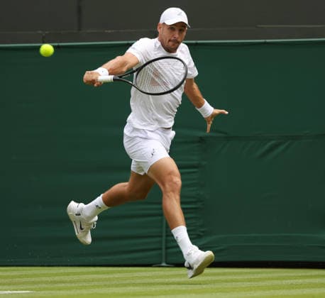 Serbian Dusan Lajovic plays a backhand in his match against American Taylor Fritz on day two of the 2026 Wimbledon Championships in London on Tuesday, June 30, 2026.  LON2026063021 HUGOxPHILPOTT