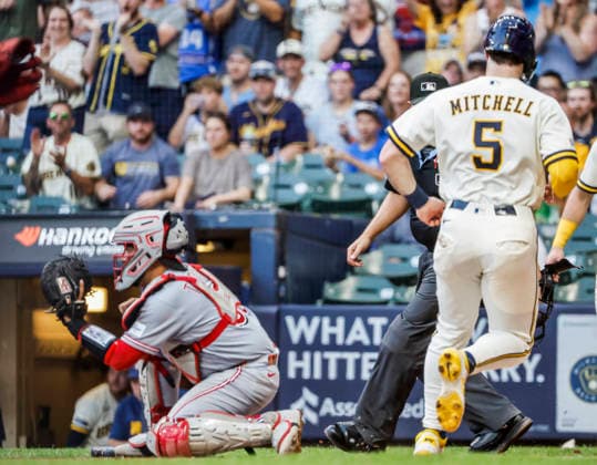 Milwaukee Brewers center fielder Garrett Mitchell (R) scores behind Cincinnati Reds catcher Jose Trevino on a single hit by Milwaukee Brewers shortstop Joey Ortiz in the fourth inning of the MLB, Baseball Herren, USA game between the Cincinnati Reds and the Milwaukee Brewers at American Family Field in Milwaukee, Wisconsin on Tuesday, June 30, 2026.  MIL20260630819 TANNENxMAURY