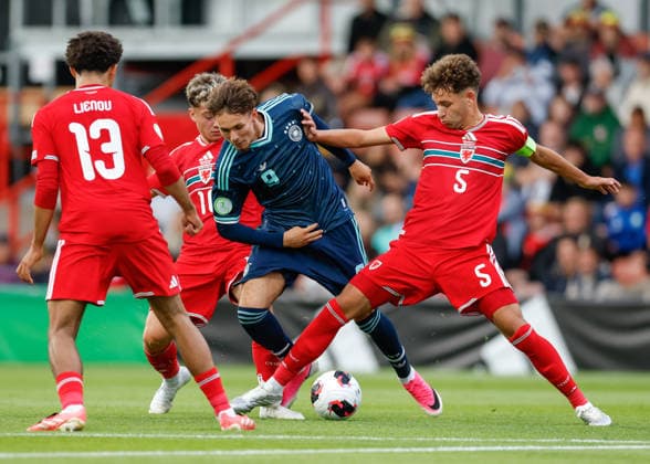 Wrexham, Wales, 1st July 2026. Brayden Clarke of Wales tackles Otto Stange of Germany during the Wales U19 vs Germany U19 UEFA European U19 Championship match at The Racecourse, Wrexham. Picture credit should read: Cody Froggatt Sportimage EDITORIAL USE ONLY. No use with unauthorised audio, video, data, fixture lists, club league logos or live services. Online in-match use limited to 120 images, no video emulation. No use in betting, games or single club league player publications. SPI_012_CF_WALES_U19_V_GERMANY_U19 SPI-4854-0012