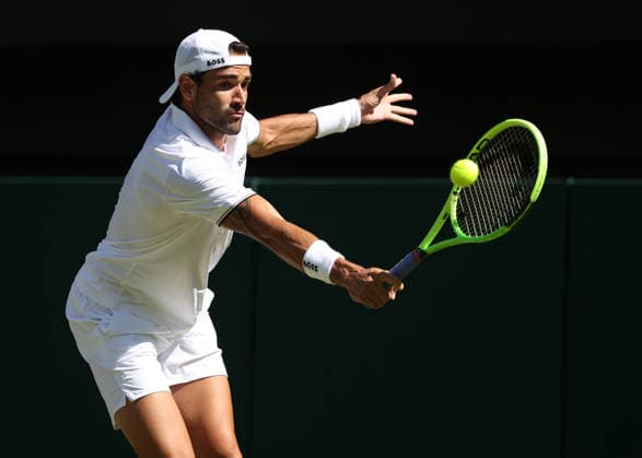 Italian Matteo Berrettini plays a backhand in his match against France s Arthur Fils at Wimbledon on day four of the 2026 Wimbledon Championships in London on Wednesday, July 2, 2026.  LON2026070246 HUGOxPHILPOTT