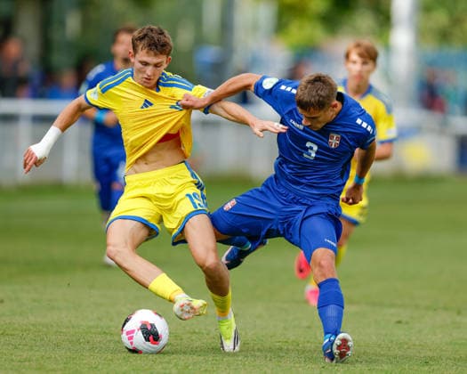Bangor, Wales, 2nd July 2026. Vitaliy Hlyut of Ukraine and Stefan Petrovic of Serbia battle for the ball during the Serbia U19 vs Ukraine U19 UEFA European U19 Championship match at Bangor City Stadium, Bangor. Picture credit should read: Cody Froggatt Sportimage EDITORIAL USE ONLY. No use with unauthorised audio, video, data, fixture lists, club league logos or live services. Online in-match use limited to 120 images, no video emulation. No use in betting, games or single club league player publications. SPI_010_CF_SERBIA_U19_V_UKRAINE_U19 SPI-4851-0010