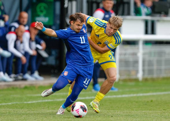 Bangor, Wales, 2nd July 2026. Jovan Ciric of Serbia holds off a challenge from Yurii Kokodyniak of Ukraine during the Serbia U19 vs Ukraine U19 UEFA European U19 Championship match at Bangor City Stadium, Bangor. Picture credit should read: Cody Froggatt Sportimage EDITORIAL USE ONLY. No use with unauthorised audio, video, data, fixture lists, club league logos or live services. Online in-match use limited to 120 images, no video emulation. No use in betting, games or single club league player publications. SPI_011_CF_SERBIA_U19_V_UKRAINE_U19 SPI-4851-0011