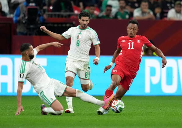 (260703) -- VANCOUVER, July 3, 2026 -- Dan Ndoye (R) of Switzerland vies with Houssem Aouar (C) and Nabil Bentaleb of Algeria during the round of 32 match between Switzerland and Algeria at the 2026 FIFA World Cup, WM, Weltmeisterschaft, Fussball at BC Place Vancouver in Vancouver, Canada, July 2, 2026. ) (SP)CANADA-VANCOUVER-FOOTBALL-FIFA WORLD CUP-ROUND OF 32-SUI VS ALG MengxYongmin 