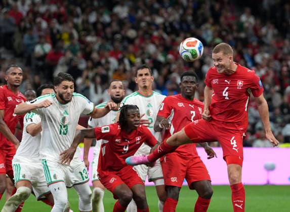 (260703) -- VANCOUVER, July 3, 2026 -- Nico Elvedi (1st R) of Switzerland heads the ball during the round of 32 match between Switzerland and Algeria at the 2026 FIFA World Cup, WM, Weltmeisterschaft, Fussball at BC Place Vancouver in Vancouver, Canada, July 2, 2026. ) (SP)CANADA-VANCOUVER-FOOTBALL-FIFA WORLD CUP-ROUND OF 32-SUI VS ALG MengxYongmin 