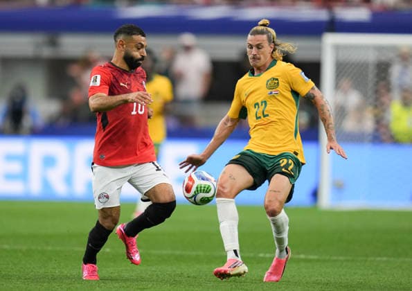 (260704) -- DALLAS, July 4, 2026 -- Jackson Irvine (R) of Australia vies with Mohamed Salah of Egypt during the round of 32 match between Australia and Egypt at the 2026 FIFA World Cup, WM, Weltmeisterschaft, Fussball at Dallas Stadium in Dallas, the United States, July 3, 2026. ) (SP)U.S.-DALLAS-FOOTBALL-FIFA WORLD CUP-ROUND OF 32-AUS VS EGY WuxXiaoling 