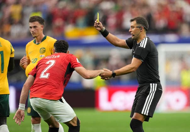 (260704) -- DALLAS, July 4, 2026 -- Referee Gustavo Tejera (R) shows a yellow card to Yasser Ibrahim of Egypt during the round of 32 match between Australia and Egypt at the 2026 FIFA World Cup, WM, Weltmeisterschaft, Fussball at Dallas Stadium in Dallas, the United States, July 3, 2026. ) (SP)U.S.-DALLAS-FOOTBALL-FIFA WORLD CUP-ROUND OF 32-AUS VS EGY WuxXiaoling 