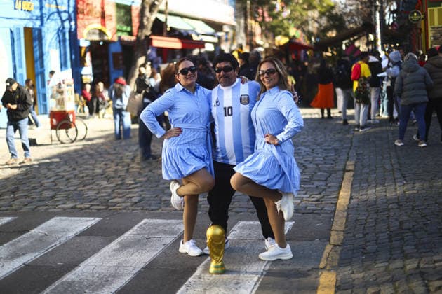 Murals across Buenos Aires depict football legends Diego Maradona and Messi BUENOS AIRES, ARGENTINA – JULY 3: A man dressed as football legend Diego Maradona poses for a photograph with two women along Caminito in the La Boca neighborhood of Buenos Aires, Argentina, on July 3, 2026. Buenos Aires is home to dozens of murals depicting football legends Lionel Messi and Diego Maradona, turning the city s streets into an open-air gallery. Neighborhoods including La Paternal, San Telmo, Palermo, La Boca, and Villa del Parque feature vibrant street art paying tribute to Argentina s two greatest football icons. The city s football culture also extends beyond the murals, with fans dressed as Messi and Maradona and shops displaying merchandise dedicated to both players. Matias Baglietto Anadolu Buenos Aires Argentina. Editorial use only. Please get in touch for any other usage.  Copyright: x2026xAnadoluxMatiasxBagliettox