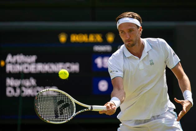 (260704) -- LONDON, July 4, 2026 -- Arthur Rinderknech of France returns the ball during the men s singles third round match against Novak Djokovic of Serbia at the Wimbledon Tennis Championships in London, Britain, on July 3, 2026. (Photo by Xinhua) (SP)BRITAIN-LONDON-TENNIS-WIMBLEDON-MEN S SINGLES StephenxChung 