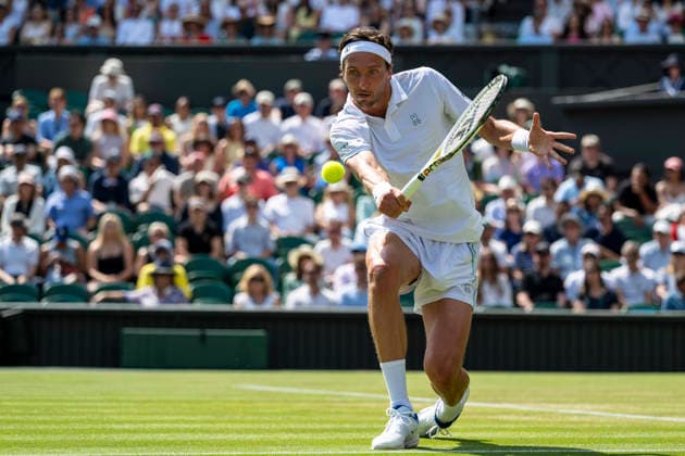 (260704) -- LONDON, July 4, 2026 -- Arthur Rinderknech of France returns the ball during the men s singles third round match against Novak Djokovic of Serbia at the Wimbledon Tennis Championships in London, Britain, on July 3, 2026. (Photo by Xinhua) (SP)BRITAIN-LONDON-TENNIS-WIMBLEDON-MEN S SINGLES StephenxChung 