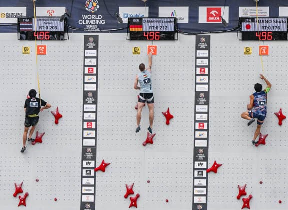 Emma Hunt Breaks Six-Second Barrier At IFSC World Climbing Series Krakow 2026 KRAKOW, POLAND - JULY 4, 2026: Leander Carmanns of Germany (C) reaches for the finish pad ahead of Aphiwit Limpanichpakdee of Thailand (L) and Shuto Fujino of Japan (R) in the men s speed climbing round of 16 during the IFSC World Climbing Series at Main Square in Krakow, Poland, July 4, 2026. Krakow Poland  Copyright: xArturxWidakx originalFilename:widak-emmahunt260704_npfej.jpg