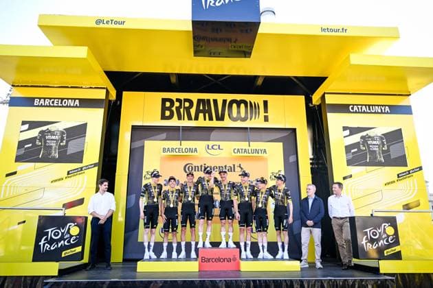 Team Visma-Lease a Bike riders celebrate on the podium after winning the first stage of the 2026 Tour de France cycling race, a team time trial of 19km with start and finish in Barcelona, Spain, Saturday 04 July 2026. The 113th edition of the Tour de France starts on Saturday 4 July in Barcelona, Spain, and will finish in Paris, France on the 26th of July. JASPERxJACOBS  x180371866x