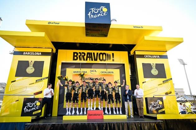 Team Visma-Lease a Bike riders celebrate on the podium after winning the first stage of the 2026 Tour de France cycling race, a team time trial of 19km with start and finish in Barcelona, Spain, Saturday 04 July 2026. The 113th edition of the Tour de France starts on Saturday 4 July in Barcelona, Spain, and will finish in Paris, France on the 26th of July. JASPERxJACOBS  x180371901x
