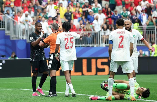 (260705) -- HOUSTON, July 5, 2026 -- Cyle Larin (1st L) of Canada is shown a yellow card during the round of 16 match between Canada and Morocco at the 2026 FIFA World Cup, WM, Weltmeisterschaft, Fussball at Houston Stadium in Houston, the United States, July 4, 2026. ) (SP)U.S.-HOUSTON-FOOTBALL-FIFA WORLD CUP-ROUND OF 16-CAN VS MAR LixMing 