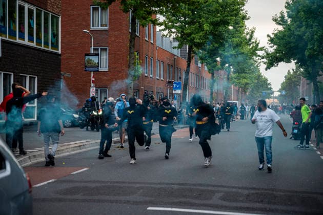 July 4, 2026, Den Haag, South Holland, Netherlands: 4 July 2026, The Hague, the Netherlands. Fans dressed as Batman flee from Dutch police. Morocco fans celebrate in the Schilderswijk neighbourhood of The Hague, after Morocco defeated Canada 3-0 in the FIFA World Cup, WM, Weltmeisterschaft, Fussball 2026 Round of 16 to advance to the quarter-finals. Fans Celebrate Morocco Win At The World Cup.  - ZUMAp202 0860756429st Copyright: xJamesxPetermeierx