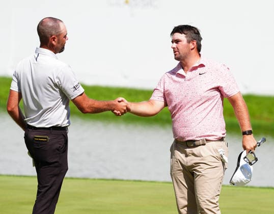 SILVIS, IL - JULY 05: PGA, Golf Herren golfer Chris Gotterup shakes the hand of Troy Merritt on the 18th green after finishing during the final round of the John Deere Classic on July 5, 2026, at TPC Deere Run in Silvis, Illinois. (Photo by Brian Spurlock Icon Sportswire) GOLF: JUL 05 PGA John Deere Classic EDITORIAL USE ONLY Icon26070549
