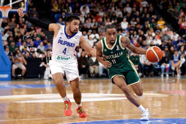 BASKETBALL AUSTRALIA PHILIPPINES, Bryce Cotton of the Australian Boomers drives past Rhon Jhay Abarrientos of the Philippines during the World Cup qualifier basketball match between Australia and the Philippines at RAC Arena in Perth, Monday, July 6, 2026. ( NO ARCHIVING, EDITORIAL USE ONLY PERTH WESTERN AUSTRALIA AUSTRALIA  Copyright: xRICHARDxWAINWRIGHTx 20260706189543655267