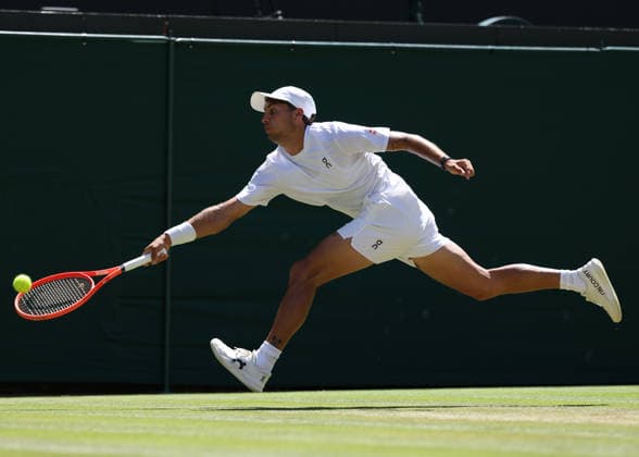 6th July 2026; All England Lawn Tennis and Croquet Club, London, England; Wimbledon Tennis Tournament, Day Eight; Flavio Cobolli (ITA) with a forehand shot to Alex De Minar (AUS) JohnxPatrickxFletcher