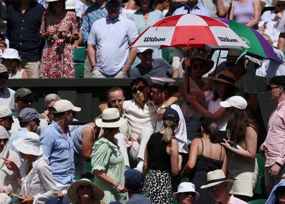 6th July 2026; All England Lawn Tennis and Croquet Club, London, England; Wimbledon Tennis Tournament, Day Eight; A spectator inside Centre Court being lifted by the other spectators and out of Centre Court due to heat stroke JohnxPatrickxFletcher