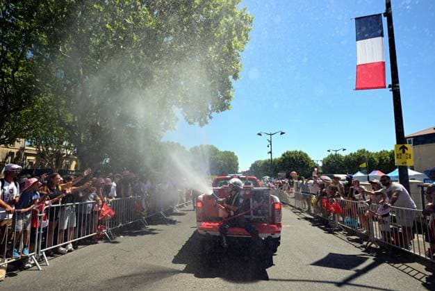 Firefighters spray the spectators with water at the start of stage 4 of the 2026 Tour de France cycling race, a stage of 181,9km from Carcassonne to Foix, on Tuesday 07 July 2026. The 113th edition of the Tour de France starts on Saturday 4 July in Barcelona, Spain, and will finish in Paris, France on the 26th of July. DAVIDxPINTENS  x180592750x