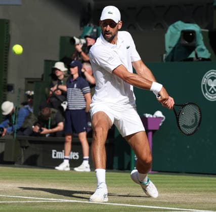 Serbian Novak Djokovic plays a backhand in his Men s Quarter-Finals match against Canada s Felix Auger Aliassime on day nine of the 2026 Wimbledon Championships in London on Tuesday, July 07, 2026.  LON2026070780 HUGOxPHILPOTT