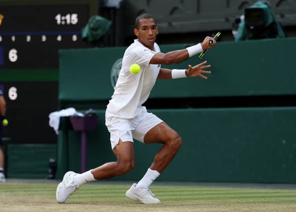RECORD DATE NOT STATED 7th July 2026; All England Lawn Tennis and Croquet Club, London, England; Wimbledon Tennis Tournament, Day Nine; Feliz Auger-Aliassime (CAN) with a backhand shot to Novak Djokovic (SRB) JohnxPatrickxFletcher
