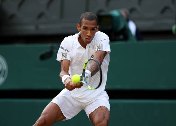 RECORD DATE NOT STATED 7th July 2026; All England Lawn Tennis and Croquet Club, London, England; Wimbledon Tennis Tournament, Day Nine; Feliz Auger-Aliassime (CAN) with a backhand shot to Novak Djokovic (SRB) JohnxPatrickxFletcher
