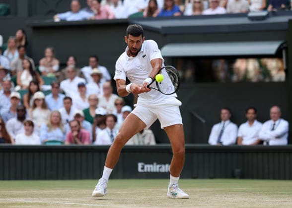 RECORD DATE NOT STATED 7th July 2026; All England Lawn Tennis and Croquet Club, London, England; Wimbledon Tennis Tournament, Day Nine; Novak Djokovic (SRB) with a backhand shot to Feliz Auger-Aliassime (CAN) JohnxPatrickxFletcher