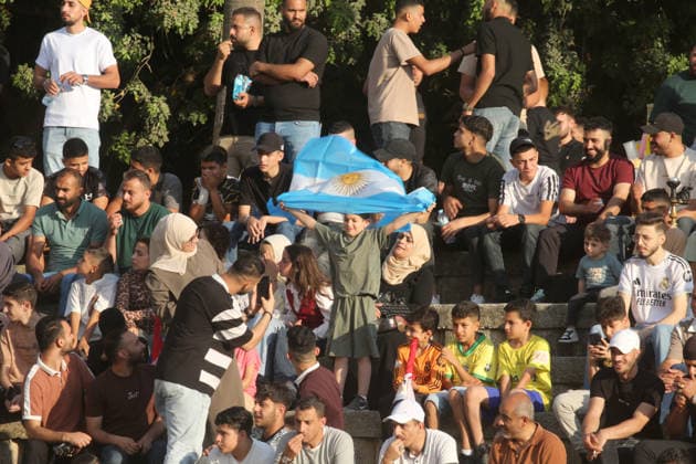 July 7, 2026, Nablus, Palestine: A Palestinian waves an Argentinian flag while watching the World Cup match between Egypt and Argentina. Palestinian fans seen at Jamal Abdel Nasser Stadium, watching the match via live World Cup broadcast big screen tv. Final scores; Argentina 3 : 2 Egypt. Nablus Palestine - ZUMAs197 20260707_aaa_s197_063 Copyright: xNasserxIshtayehx