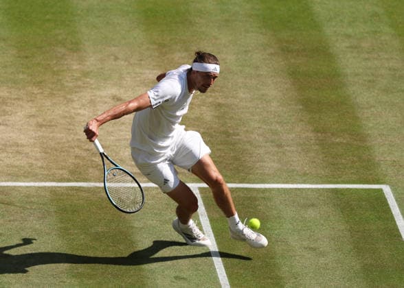RECORD DATE NOT STATED 8th July 2026; All England Lawn Tennis and Croquet Club, London, England; Wimbledon Tennis Tournament, Day Ten; Alexander Zverev (GER) with a backhand shot to Taylor Fritz (USA) JohnxPatrickxFletcher