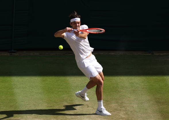 RECORD DATE NOT STATED 8th July 2026; All England Lawn Tennis and Croquet Club, London, England; Wimbledon Tennis Tournament, Day Ten; Taylor Fritz (USA) with a backhand shot to Alexander Zverev (GER) JohnxPatrickxFletcher