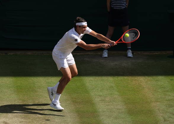 RECORD DATE NOT STATED 8th July 2026; All England Lawn Tennis and Croquet Club, London, England; Wimbledon Tennis Tournament, Day Ten; Taylor Fritz (USA) with a backhand shot to Alexander Zverev (GER) JohnxPatrickxFletcher