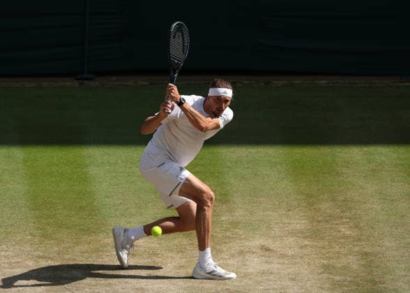 RECORD DATE NOT STATED 8th July 2026; All England Lawn Tennis and Croquet Club, London, England; Wimbledon Tennis Tournament, Day Ten; Alexander Zverev (GER) with a backhand shot to Taylor Fritz (USA) JohnxPatrickxFletcher