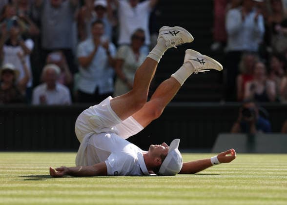 RECORD DATE NOT STATED 8th July 2026; All England Lawn Tennis and Croquet Club, London, England; Wimbledon Tennis Tournament, Day Ten; Arthur Fery (GBR) falls onto the court in celebration following victory over Flavio Cobolli (ITA) to reach the Gentlemens Semi Final for the first time as a wild card JohnxPatrickxFletcher