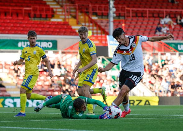 Wrexham, Wales, 8th July 2026. Mirza Catovic of Germany has his shot saved by Nazar Domchak of Ukraine during the Ukraine U19 vs Germany U19 UEFA European U19 Championship match at The Racecourse, Wrexham. Picture credit should read: Cody Froggatt Sportimage EDITORIAL USE ONLY. No use with unauthorised audio, video, data, fixture lists, club league logos or live services. Online in-match use limited to 120 images, no video emulation. No use in betting, games or single club league player publications. SPI_014_CF_UKRAINE_U19_V_GERMANY_U19 SPI-4857-0013
