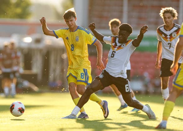 Wrexham, Wales, 8th July 2026. Boris Mamuzah Lum of Germany tackles Pavlo Liusin of Ukraine during the Ukraine U19 vs Germany U19 UEFA European U19 Championship match at The Racecourse, Wrexham. Picture credit should read: Cody Froggatt Sportimage EDITORIAL USE ONLY. No use with unauthorised audio, video, data, fixture lists, club league logos or live services. Online in-match use limited to 120 images, no video emulation. No use in betting, games or single club league player publications. SPI_030_CF_UKRAINE_U19_V_GERMANY_U19 SPI-4857-0029
