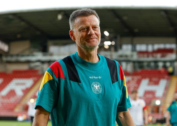 Wrexham, Wales, 8th July 2026. Christian Worns head coach of Germany all smiles as he celebrates the full time result as Germany qualify for the UEFA European U19 Championship final following the Ukraine U19 vs Germany U19 UEFA European U19 Championship match at The Racecourse, Wrexham. Picture credit should read: Cody Froggatt Sportimage EDITORIAL USE ONLY. No use with unauthorised audio, video, data, fixture lists, club league logos or live services. Online in-match use limited to 120 images, no video emulation. No use in betting, games or single club league player publications. SPI_055_CF_UKRAINE_U19_V_GERMANY_U19 SPI-4857-0054